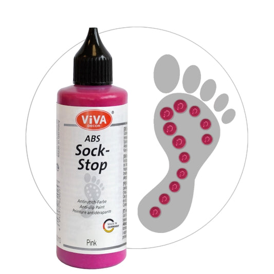 Viva Decor ABS Sock-Stop antislip-verf in de kleur pink, flesje met puntdop, naast een voetafdruk met roze antislip-stippen op de zool